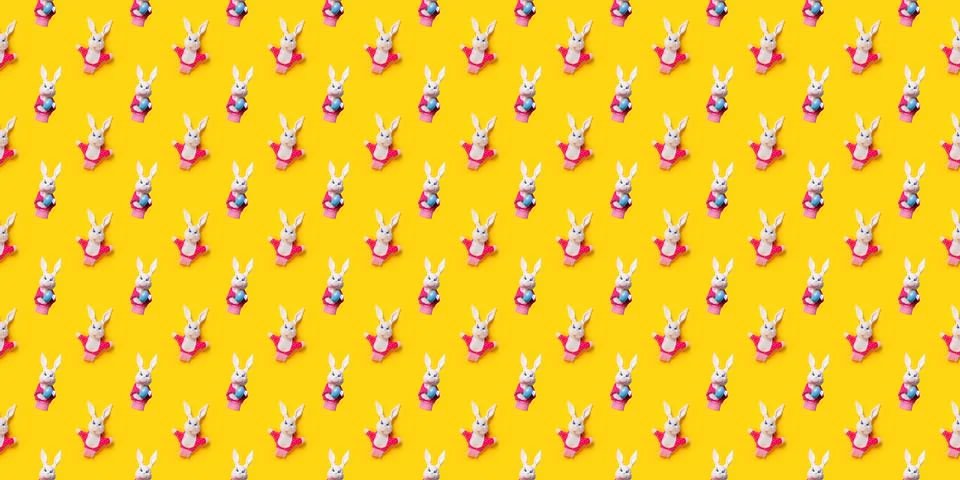 Seamless pattern with Easter bunny and egg isolated on yellow background. Fun 스톡 사진