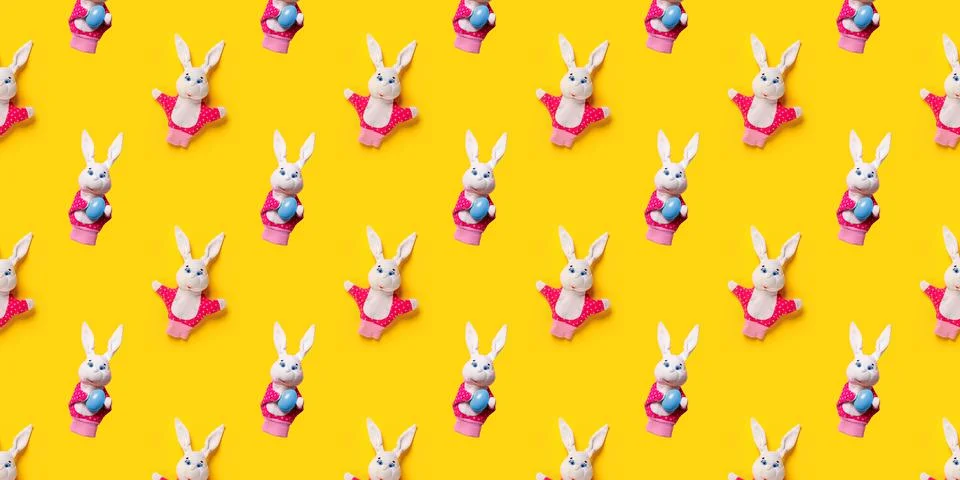 Seamless pattern with Easter bunny and egg isolated on yellow background. Funny 스톡 사진