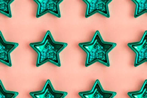 Seamless pattern from five pointed mint metallic star on pink surface Stock Photos