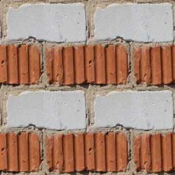 Seamless pattern of fragment of red and white stone wall Stock Photos