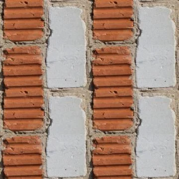 Seamless pattern of fragment of red and white stone wall Stock Photos