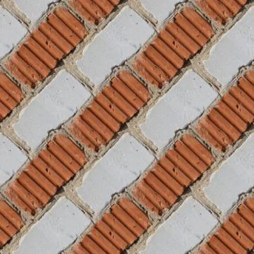 Seamless pattern of fragment of red and white stone wall Stock Photos