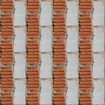 Seamless pattern of fragment of red and white stone wall Stock Photos