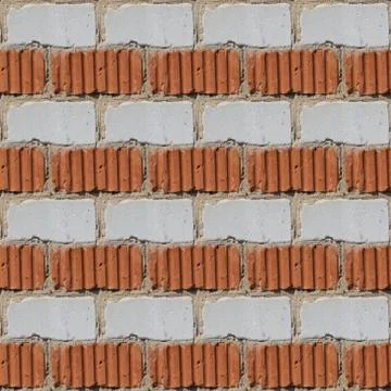 Seamless pattern of fragment of red and white stone wall Stock Photos