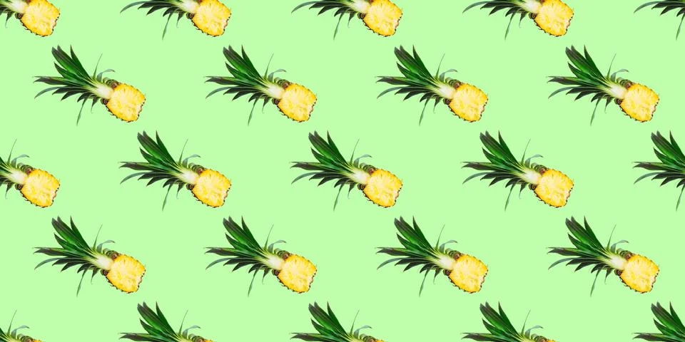 Seamless pattern of fresh pineapple halves isolated on green background.Top view Stock Photos