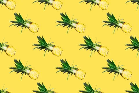 Seamless pattern of fresh pineapple halves isolated on yellow background.Top Stock Photos