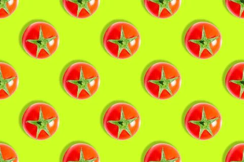 Seamless pattern of fresh ripe cherry tomatoes isolated on green background Stock Photos