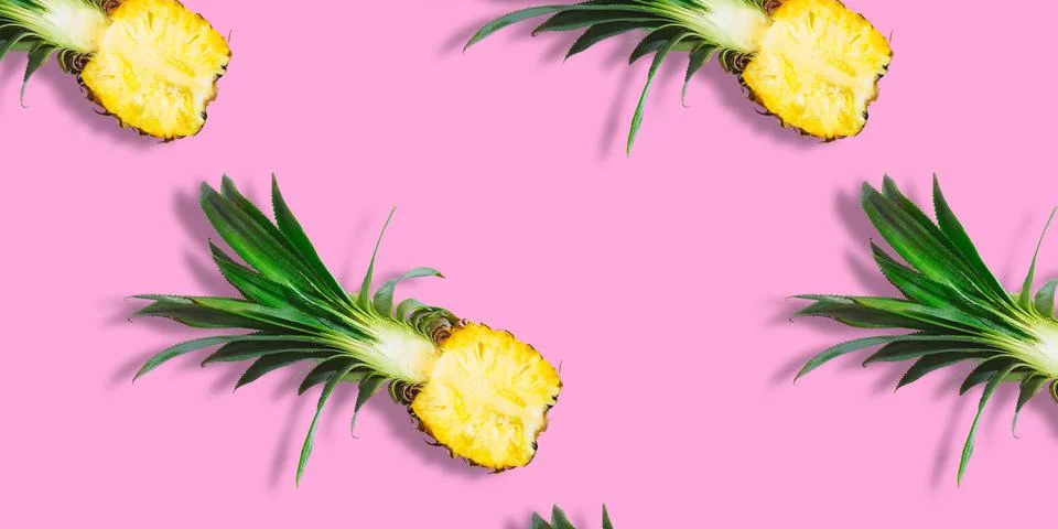 Seamless pattern of fresh ripe pineapple halves isolated on pink background Stock Photos