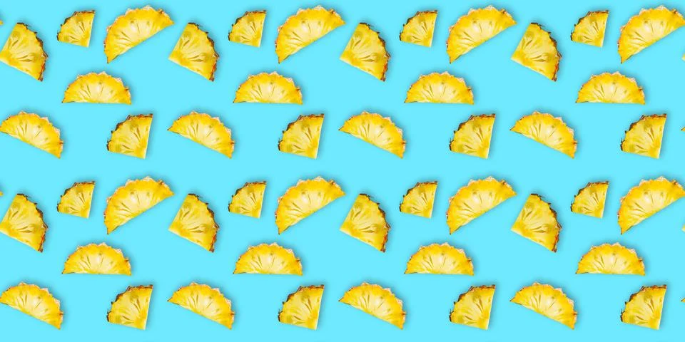 Seamless pattern of fresh ripe pineapple slices isolated on cyan background Stock Photos