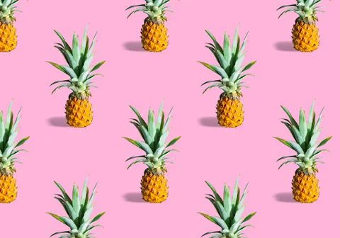 Seamless pattern of fresh ripe pineapples isolated on pink background Stock Photos