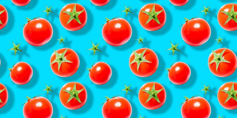 Seamless pattern of fresh ripe red cherry tomatoes isolated on blue background Stock Photos