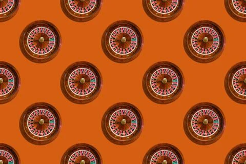 Seamless pattern of game table roulette from elite casino on orange backgroun Stock Photos
