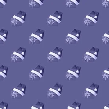 Seamless pattern with gift boxes wearing Santa hat on Very Peri background. 写真素材