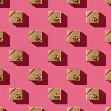 Seamless pattern of golden gift box over red pink background. Stock Photos
