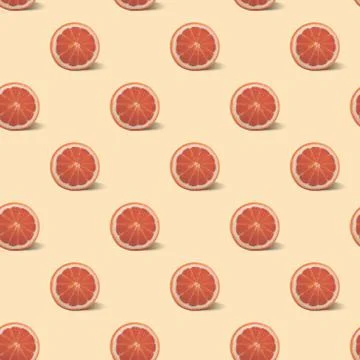 Seamless pattern with grapefruit on a pale light pink background. Stock Photos