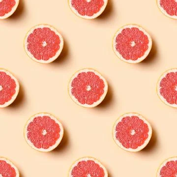 Seamless pattern of grapefruit slice on beige. Food pattern. Stock Photos