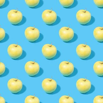 Seamless pattern of green apples on a blue background Stock Photos