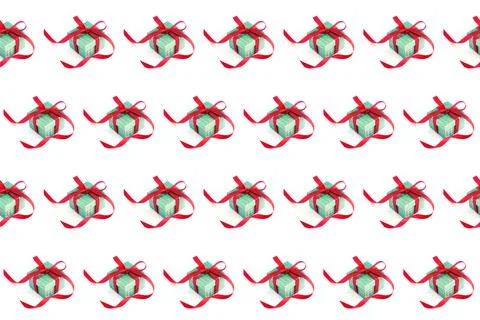 Seamless pattern. A green gift box with a red ribbon and a bow on white Stock Photos