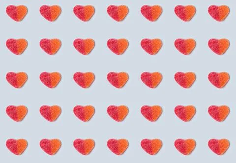 Seamless pattern of gummy hearts on light blue background Stock Photos