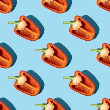 Seamless pattern of half red pepper on blue background. Stock Photos