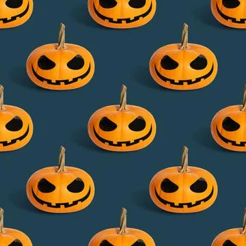 Seamless pattern with halloween pumpkin on a blue background. Jack o lantern  Stock Photos