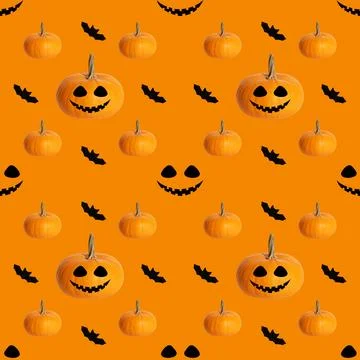 Seamless pattern with Halloween pumpkin Jack head and bats on an orange  Stock Photos