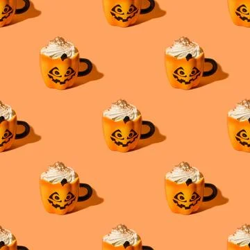 Seamless pattern of Halloween pumpkin latte on orange background. Stock Photos