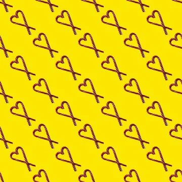 Seamless pattern heart shape with Christmas candies on a yellow background, t 스톡 사진