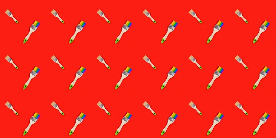 Seamless pattern with the image of a brush on red background. Stock Photos