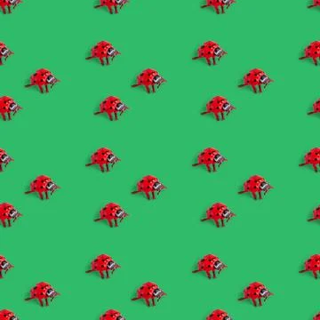 Seamless pattern with a ladybug on a green background. holiday concept Stock Photos