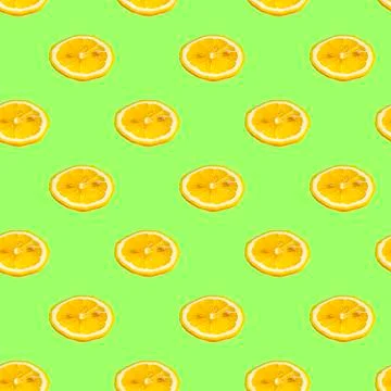 Seamless pattern with lemon slices on a salad background. Minimal isometric t Stock Photos