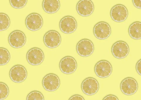 Seamless pattern of lemon slices with shadows on a light yellow background Stock Photos
