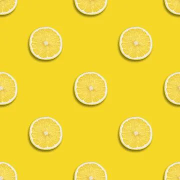 Seamless pattern with lemon on a yellow background. Lemon slices  Stock Photos