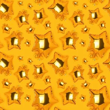 Seamless pattern made of golden foil balloons in a star shape. Stock Photos