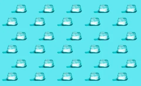 Seamless pattern made of melting ice cubes on a light-blue background Stock Photos