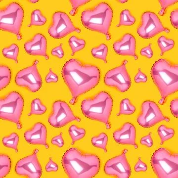 Seamless pattern made of pink inflatable balloons in a heart shape. Stock Photos