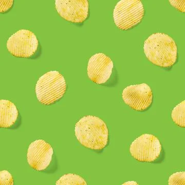 Seamless pattern made from Potato chips on green background flat lay. potato Stock Photos