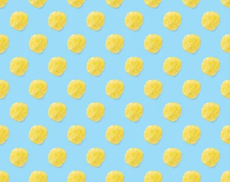 Seamless pattern made from Potato chips on light blue background flat lay Stock Photos