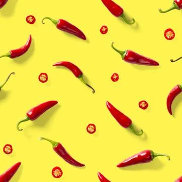 Seamless pattern made of red chili or chilli on yellow background. Minimal fo Stock Photos