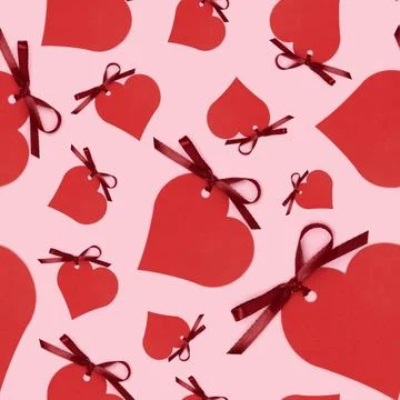 Seamless pattern made of red empty tags in a heart shape with tied ribbon bow 스톡 사진