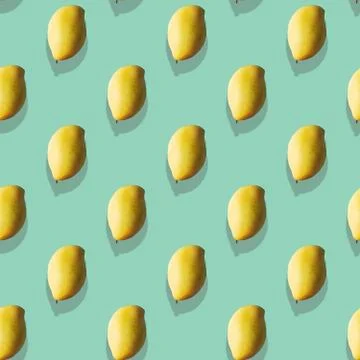 Seamless Pattern made with ripe yellow mango fruit over mint background. Stock Photos