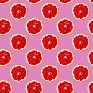 Seamless Pattern made with slice of red orange fruit over pink color backgrou Stock Illustration