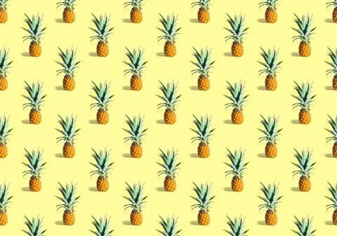 Seamless pattern of many ripe pineapples isolated on yellow background. Tropical Stock Photos