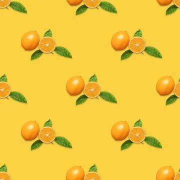 Seamless pattern with Meyer lemon and green leaves on yellow background. Stock Photos
