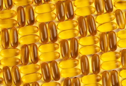 Seamless pattern of omega 3 capsules on a white background. Stock Photos