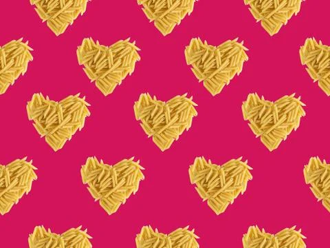 Seamless pattern with pasta on a pink background. Heart shaped pasta. Favorit Stock Photos