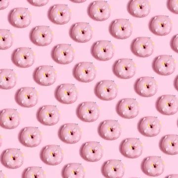 Seamless pattern of pink donuts on a light pink background Stock Photos