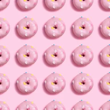 Seamless Pattern of pink donuts on a light pink background Stock Photos