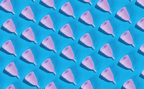 Seamless pattern of a pink menstrual cup made of delicate medical silicone on Stock Photos