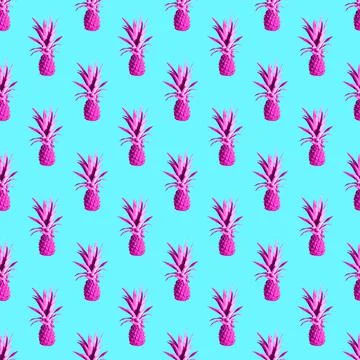 Seamless pattern of pink pineapples isolated on blue background Stock Photos